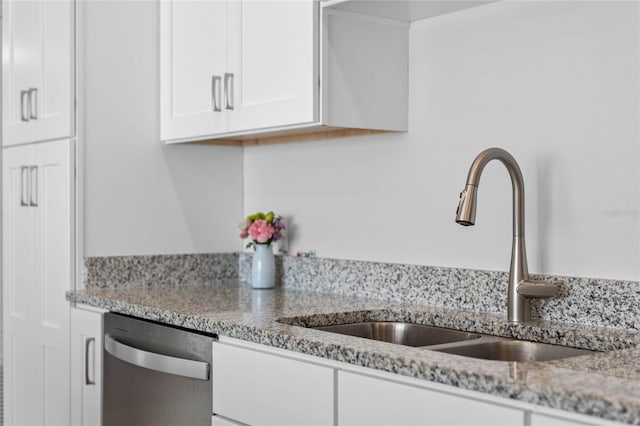 kitchen featuring white cabinetry, dishwasher, sink, and light stone counters