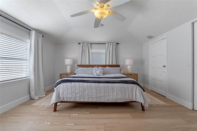 bedroom featuring vaulted ceiling, ceiling fan, and light wood-type flooring