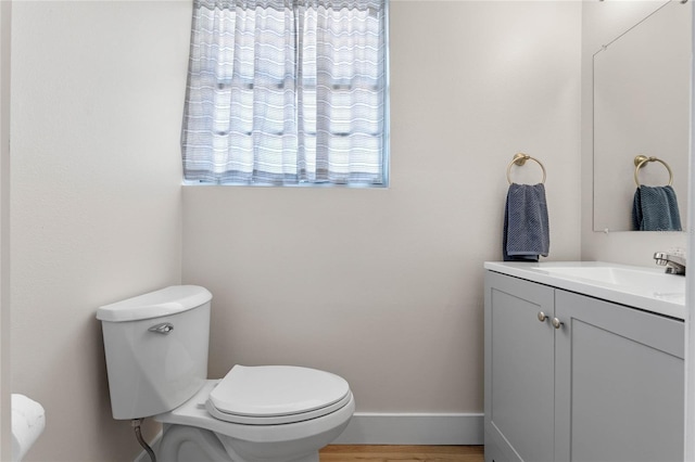 bathroom featuring hardwood / wood-style flooring, vanity, and toilet