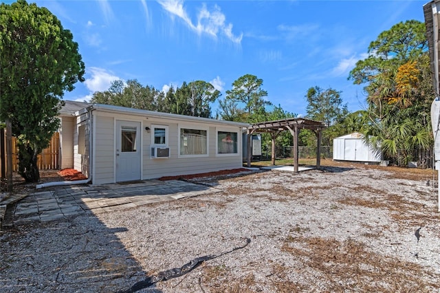 view of front of home featuring a storage shed and a pergola