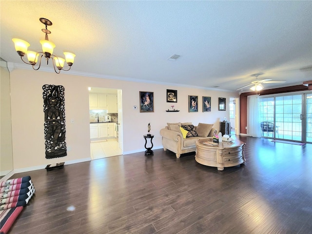 living room with crown molding, ceiling fan with notable chandelier, hardwood / wood-style floors, and a textured ceiling