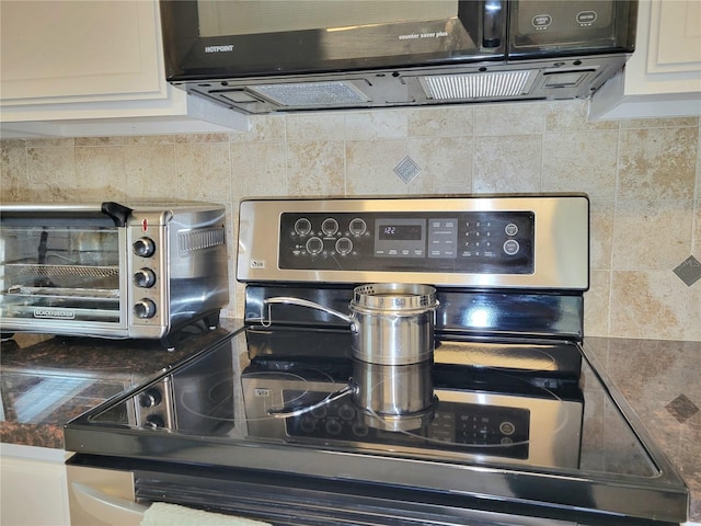 room details featuring a mail area, white cabinets, and stainless steel electric range