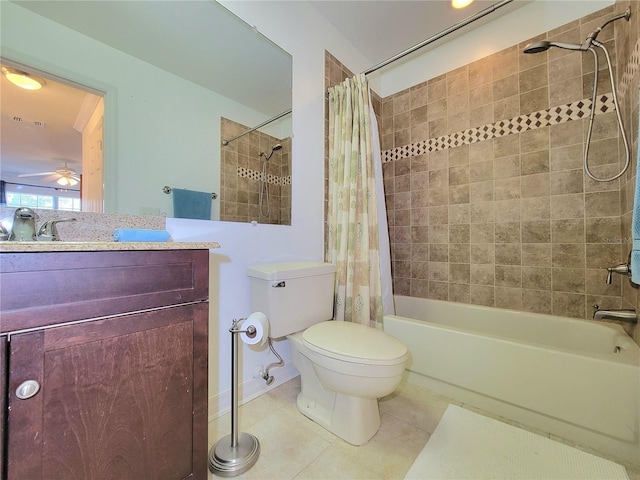 full bathroom featuring ceiling fan, vanity, shower / bath combination with curtain, tile patterned floors, and toilet