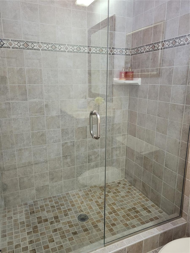 bathroom with a shower with door