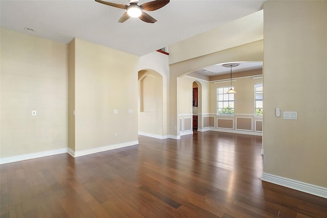 unfurnished room with dark wood-type flooring and ceiling fan