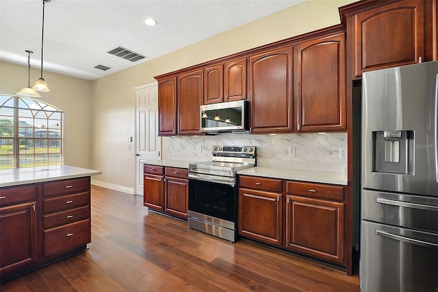 kitchen featuring tasteful backsplash, a textured ceiling, dark hardwood / wood-style floors, pendant lighting, and stainless steel appliances