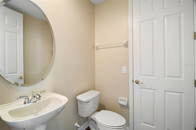 bathroom featuring toilet and sink