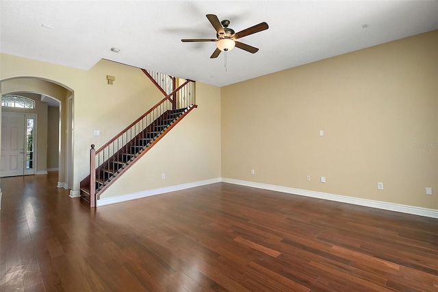 interior space with ceiling fan and dark hardwood / wood-style flooring