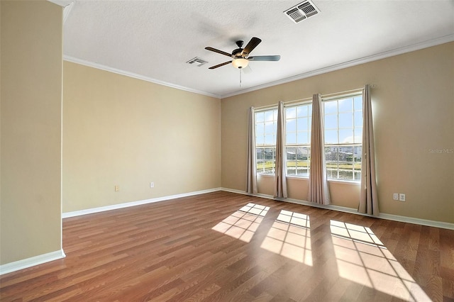 spare room featuring hardwood / wood-style flooring, ceiling fan, ornamental molding, and a textured ceiling