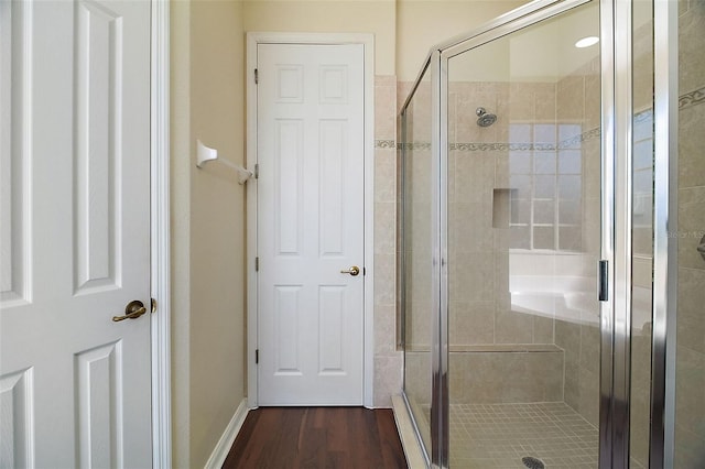 bathroom featuring a shower with door and wood-type flooring