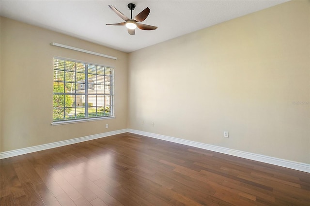 empty room with dark wood-type flooring and ceiling fan