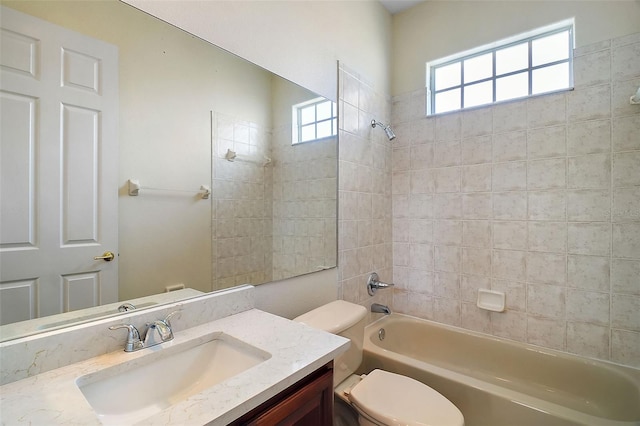 full bathroom with vanity, toilet, and tiled shower / bath