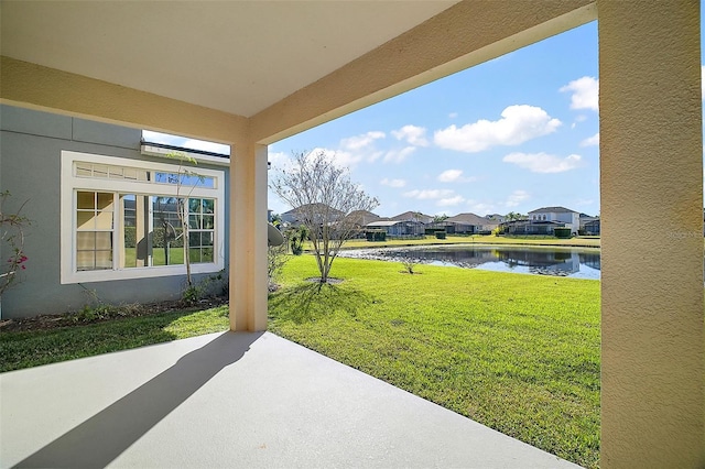 view of yard featuring a water view and a patio