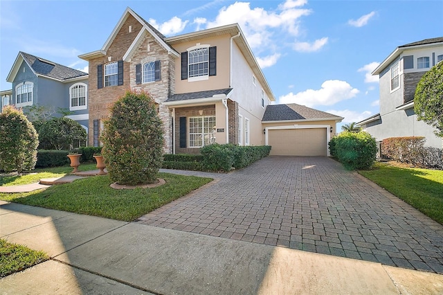 view of property featuring a garage and a front yard