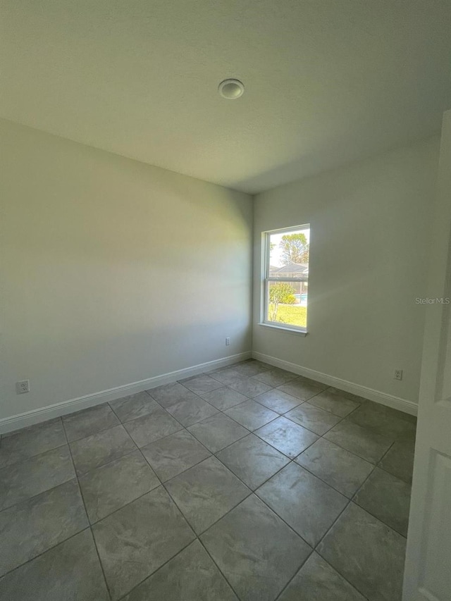 empty room featuring baseboards