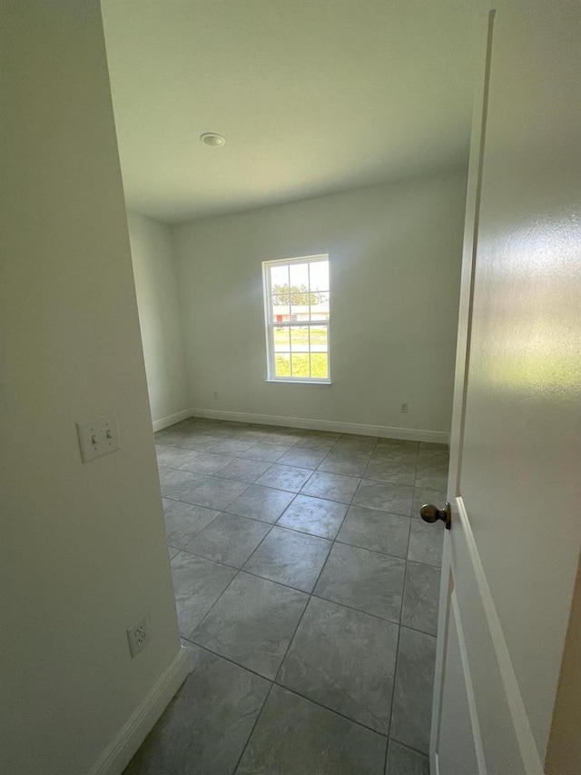 spare room with baseboards