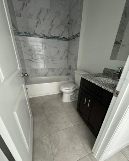 bathroom with toilet, bathing tub / shower combination, and vanity