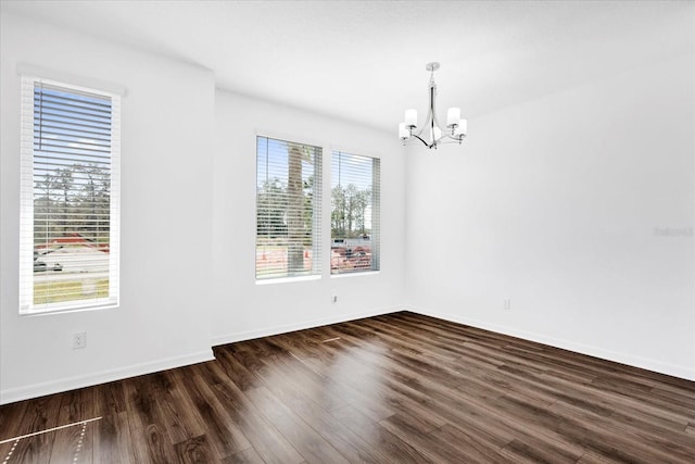 unfurnished dining area with dark hardwood / wood-style floors and a chandelier