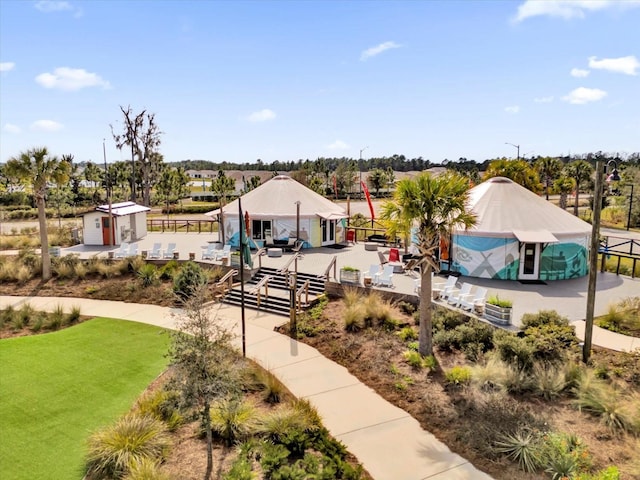 surrounding community featuring a lawn and a storage unit