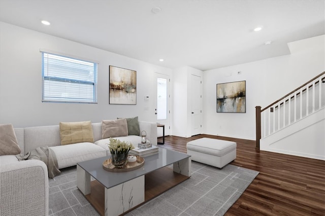 living area featuring stairway, recessed lighting, baseboards, and wood finished floors