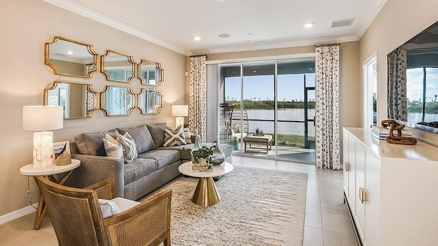 living room featuring light tile patterned floors, crown molding, and a water view