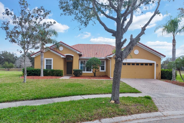 ranch-style home with a garage and a front lawn