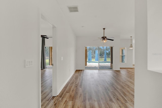 unfurnished living room featuring ceiling fan and light wood-type flooring