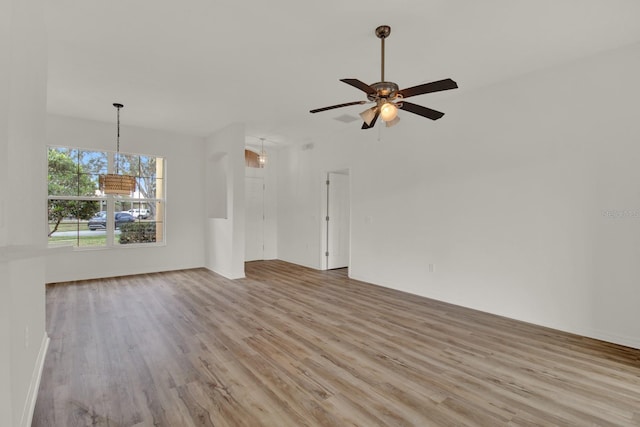 unfurnished living room featuring ceiling fan and light hardwood / wood-style floors