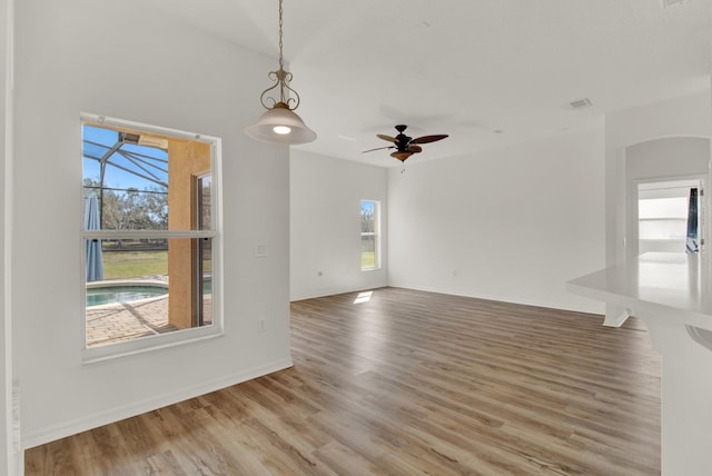 unfurnished living room featuring ceiling fan and wood-type flooring