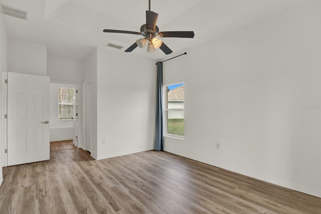 spare room with ceiling fan and light wood-type flooring