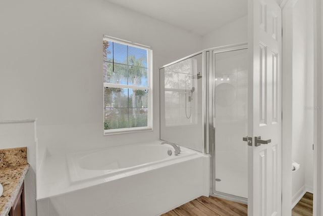 bathroom with vanity, separate shower and tub, and hardwood / wood-style floors