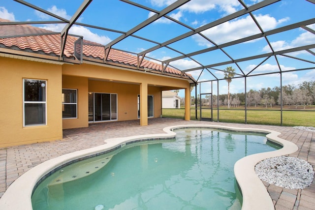 view of pool featuring a patio area and glass enclosure