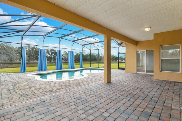 view of pool featuring a lanai, a lawn, and a patio