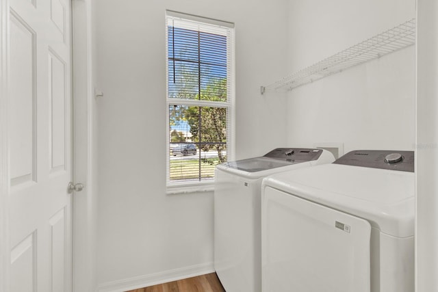 laundry room with separate washer and dryer and light wood-type flooring