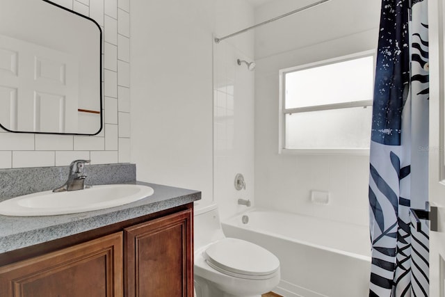 full bathroom with vanity, shower / bath combo, and toilet