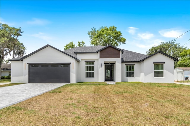 view of front of home with a garage and a front lawn