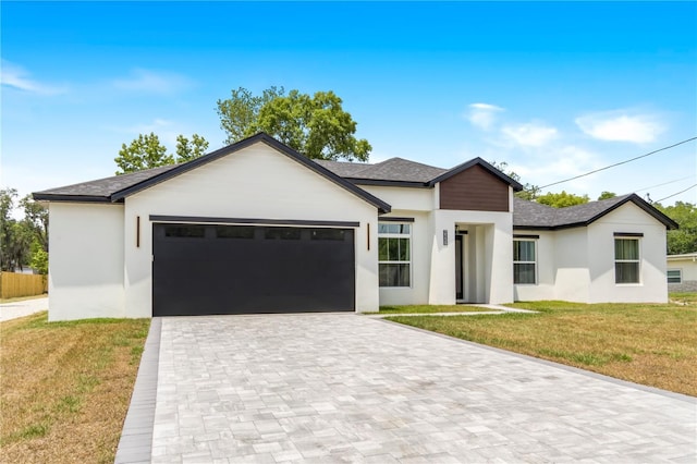 view of front of property featuring a garage and a front yard