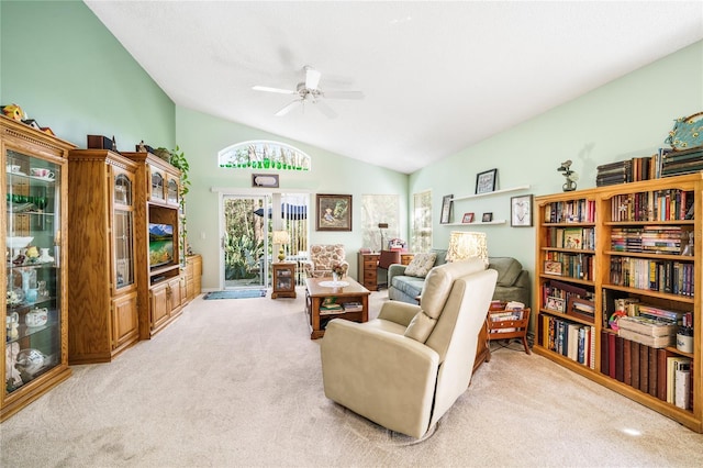 living area featuring light colored carpet, vaulted ceiling, and ceiling fan