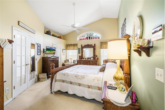 bedroom with vaulted ceiling, a ceiling fan, and light colored carpet