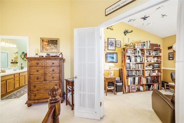 sitting room with light carpet and vaulted ceiling