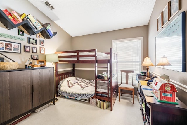 bedroom featuring light carpet, visible vents, and baseboards