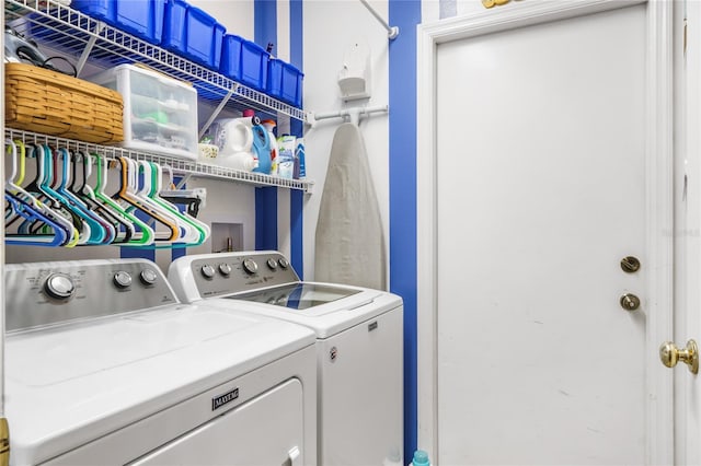 clothes washing area with laundry area and washer and clothes dryer