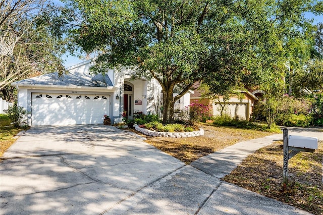 view of front of home featuring a garage, concrete driveway, and stucco siding