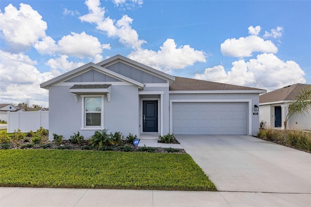 view of front of property with a garage and a front yard