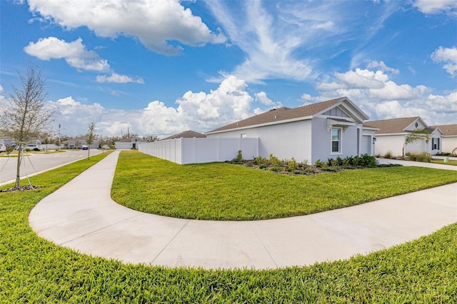 view of side of home featuring a lawn