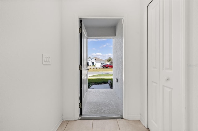 doorway with light tile patterned floors