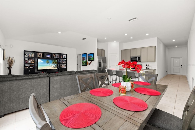 tiled dining area featuring lofted ceiling