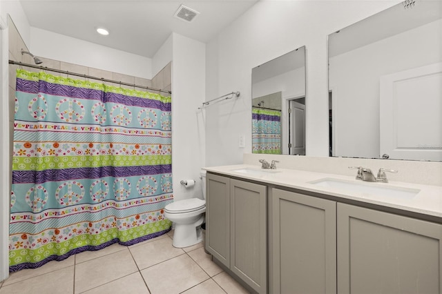 bathroom featuring vanity, curtained shower, tile patterned floors, and toilet