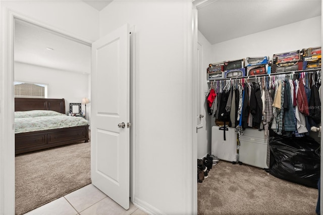 spacious closet featuring light colored carpet