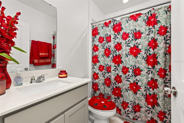 bathroom featuring vanity, toilet, and curtained shower